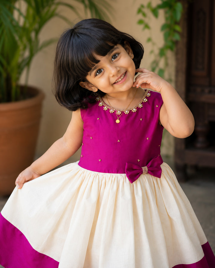Cream and magenta Kerala handloom Onam special frock for baby girl – front view, Stanwells Kids