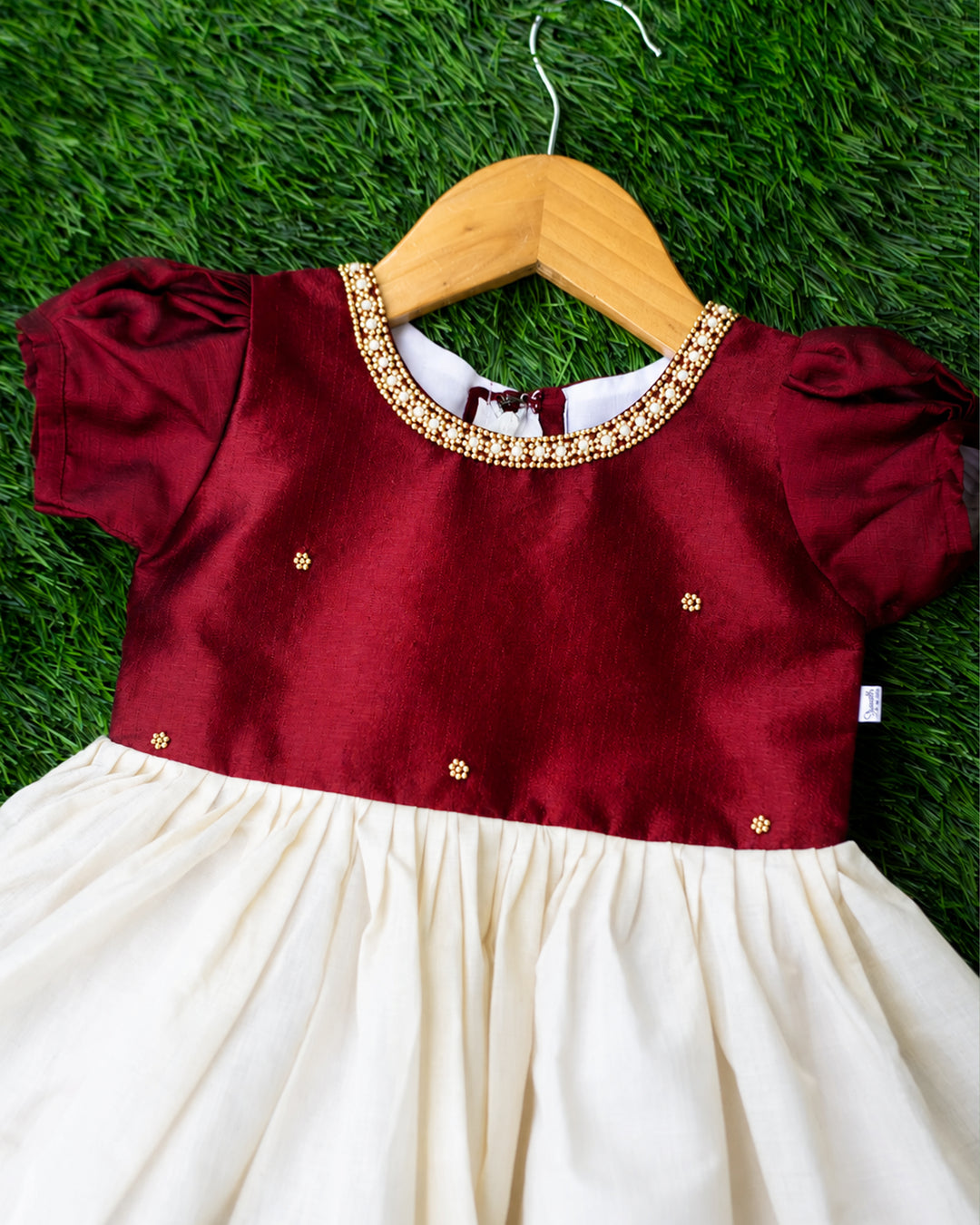 Round neck hand embroidery detail on cream maroon Kerala frock for baby girls, stanwells kids
