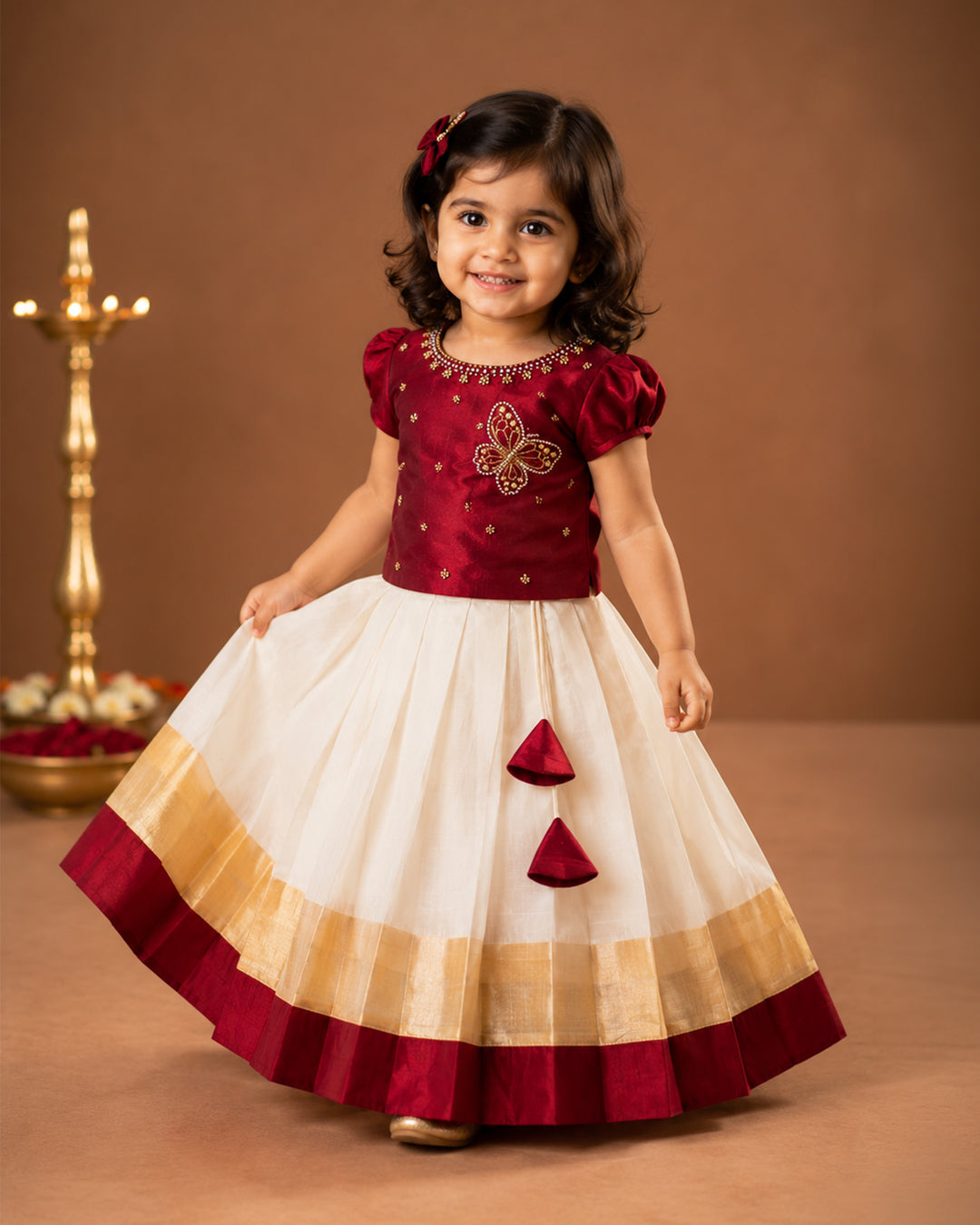 First Onam baby girl wearing cream maroon butterfly Kasavu lehenga, Stanwells Kids