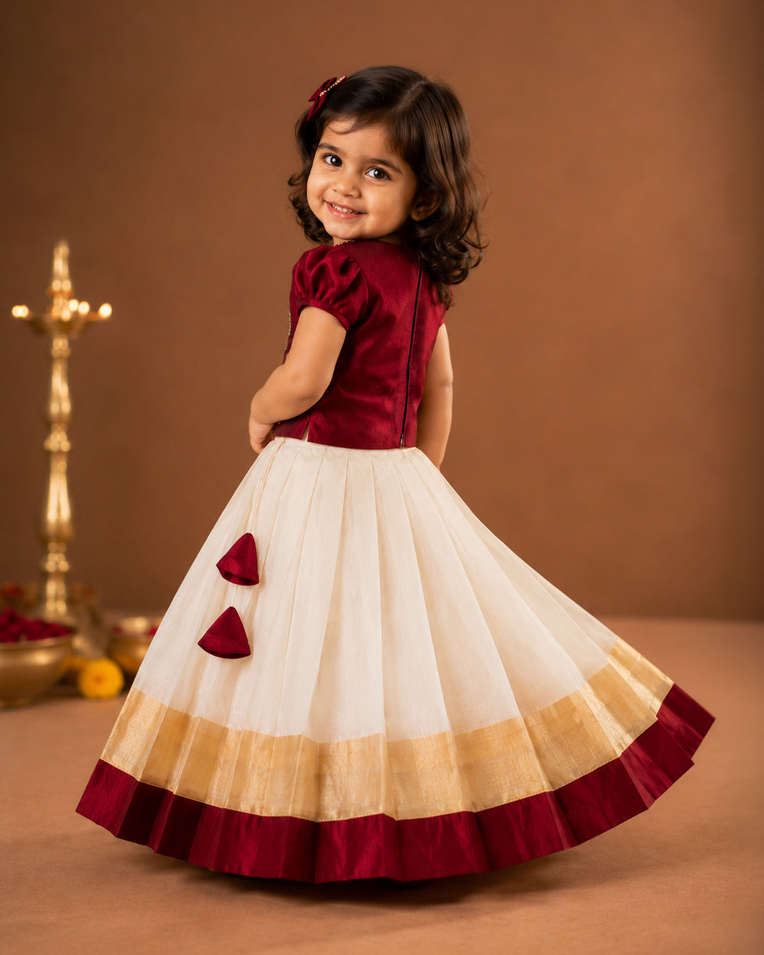 First Onam baby girl wearing cream maroon butterfly Kasavu lehenga, Stanwells Kids