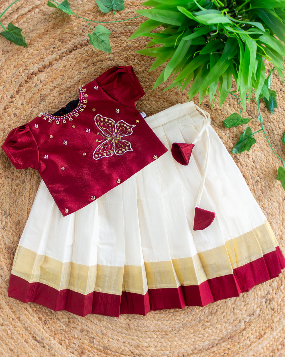 First Onam baby girl wearing cream maroon butterfly Kasavu lehenga, Stanwells Kids