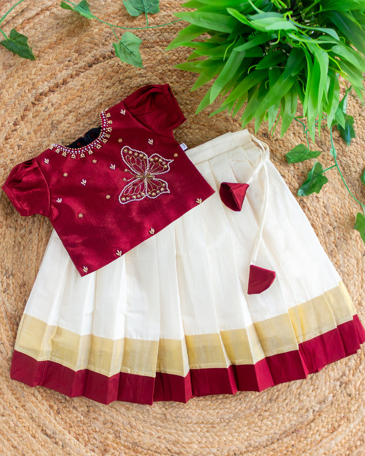 First Onam baby girl wearing cream maroon butterfly Kasavu lehenga, Stanwells Kids