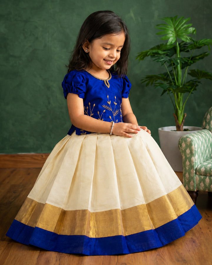 Front view of cream Kasavu lehenga with royal blue blouse