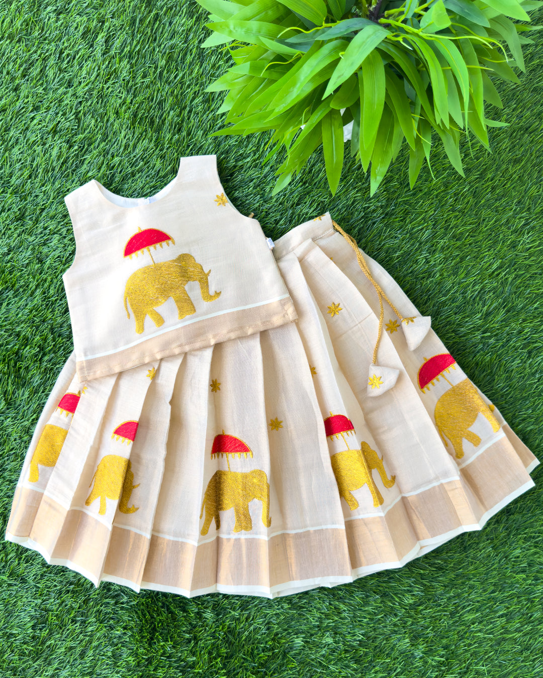 First Onam baby girl wearing cream gold elephant embroidery Kasavu lehenga, Stanwells Kids