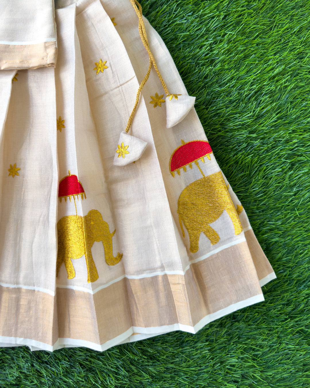 Cream Kasavu pleated skirt with elephant embroidery for First Onam, Stanwells Kids