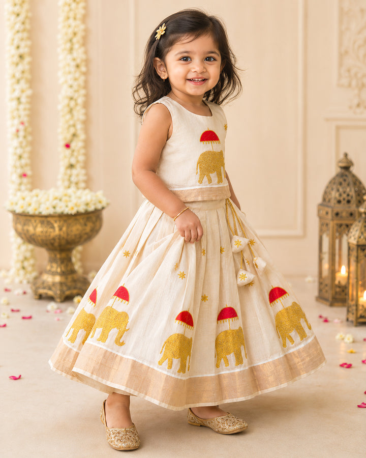 First Onam baby girl wearing cream gold elephant embroidery Kasavu lehenga, Stanwells Kids