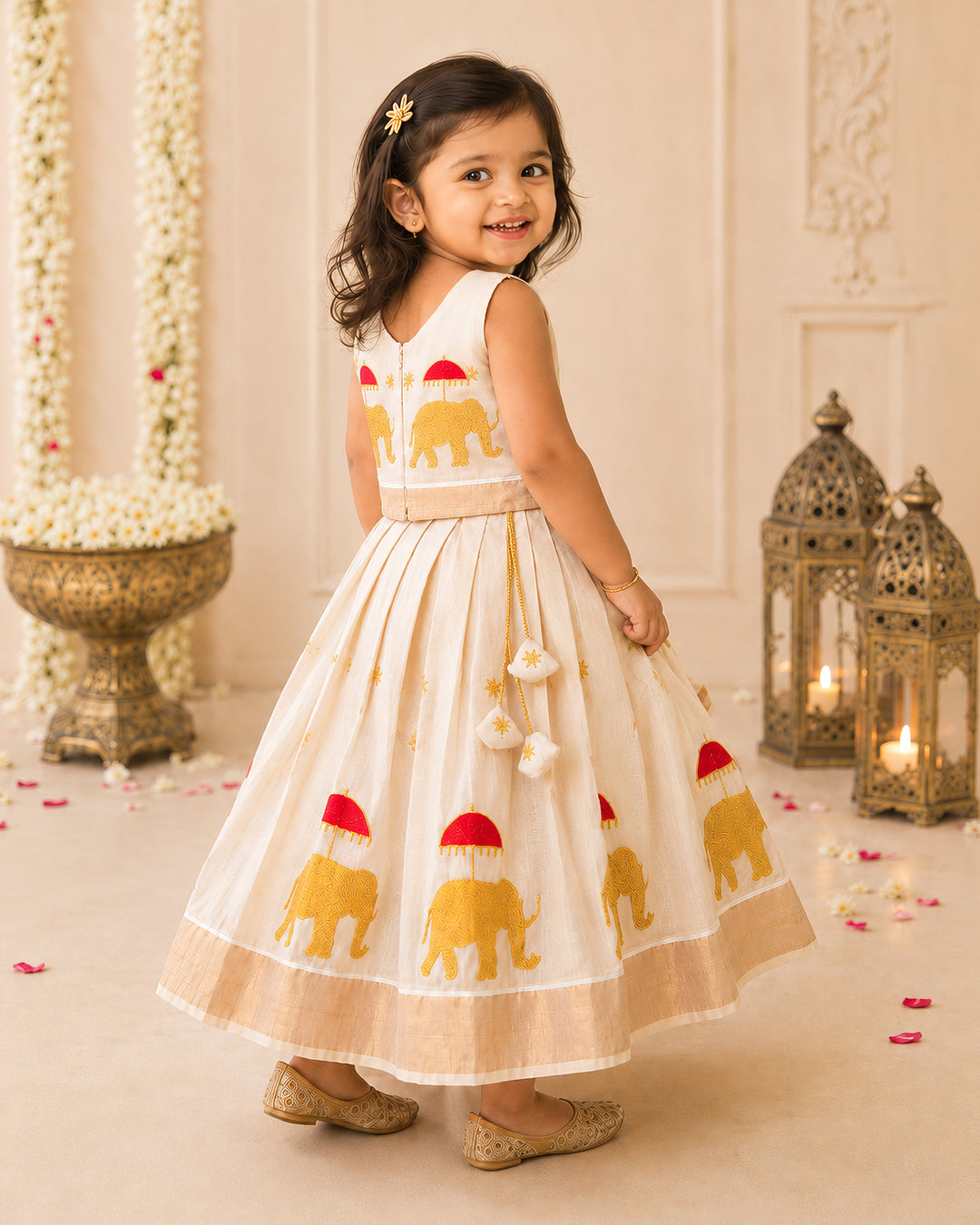 First Onam baby girl wearing cream gold elephant embroidery Kasavu lehenga, Stanwells Kids