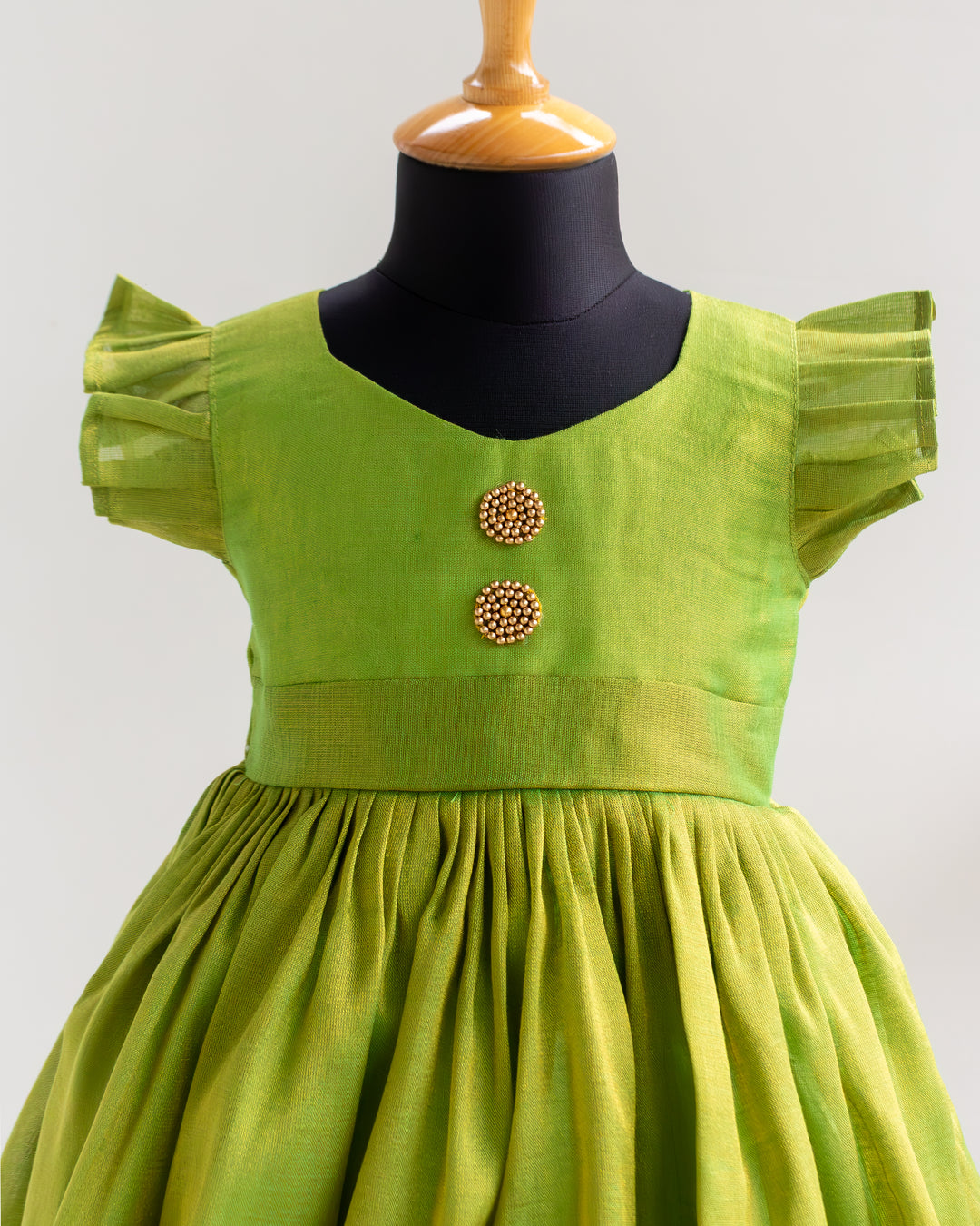 Traditional green silk frock with golden bead yoke – kids ethnic wear, Stanwells Kids