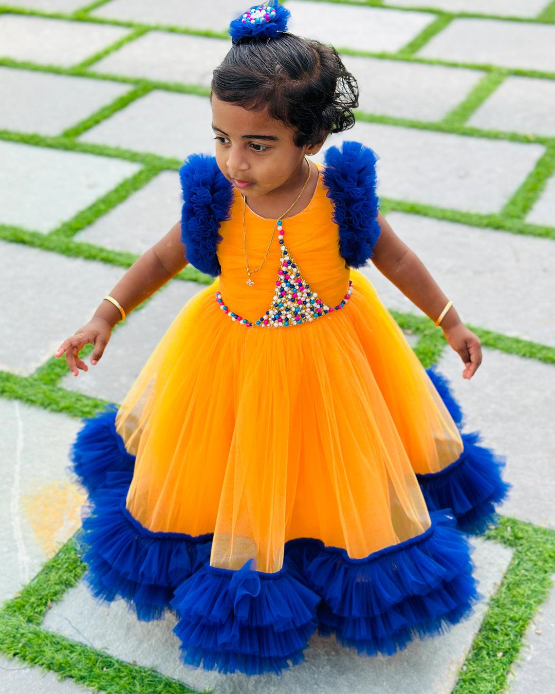 Sun Yellow & Navy blue combo Paris Handwork Birthday Gown
Material: Sun Yellow &amp; Navy blue soft nylon net is used for making this beautiful Gown .Yoke portion of the gown is designed with yellow net with multi colours 