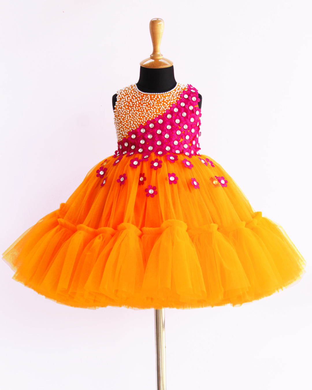 Mango Yellow & Magenta combo Handwork Flower Frock
Material: Mango yellow colour net is used to make this elegant dress. Magenta colour satin flowers are spreaded on one side of the frock. Another side of the frock 