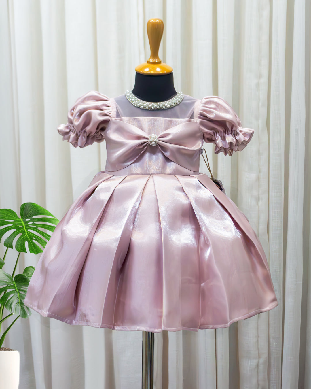 Metallic pink glossy satin flared partywear bow frock for baby girl – front view, Stanwells Kids