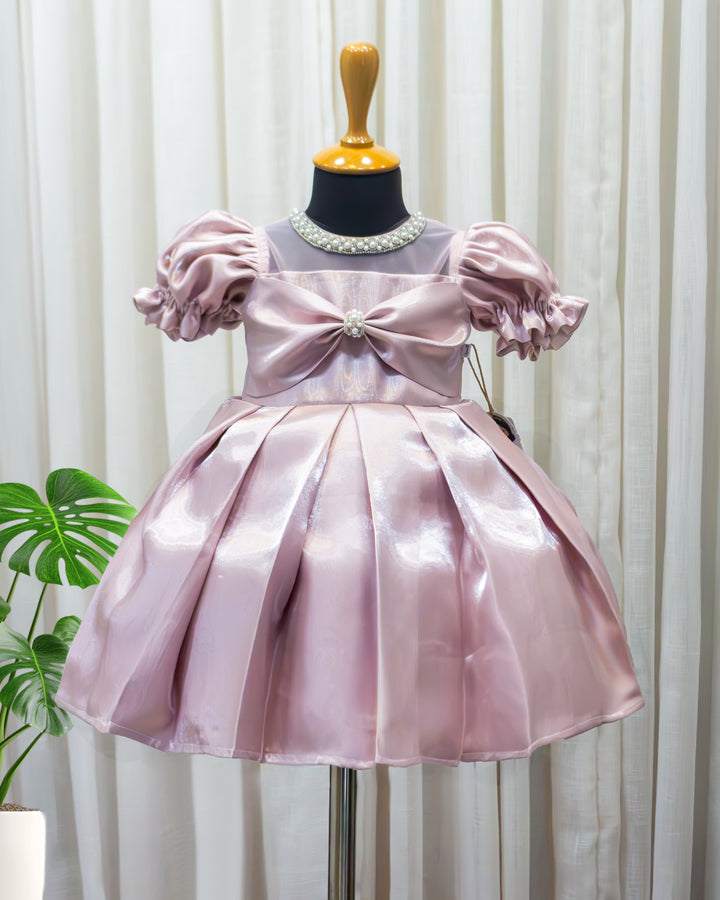 Metallic pink glossy satin flared partywear bow frock for baby girl – front view, Stanwells Kids
