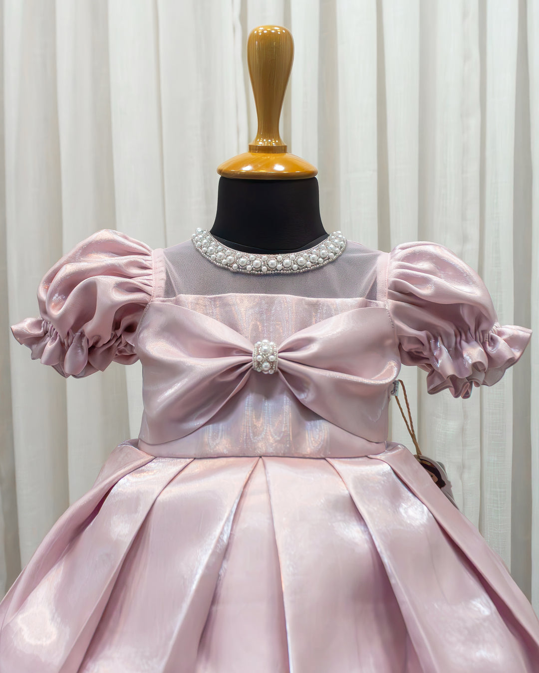 Charming bow accent detail on metallic pink satin partywear frock – Stanwells Kids
