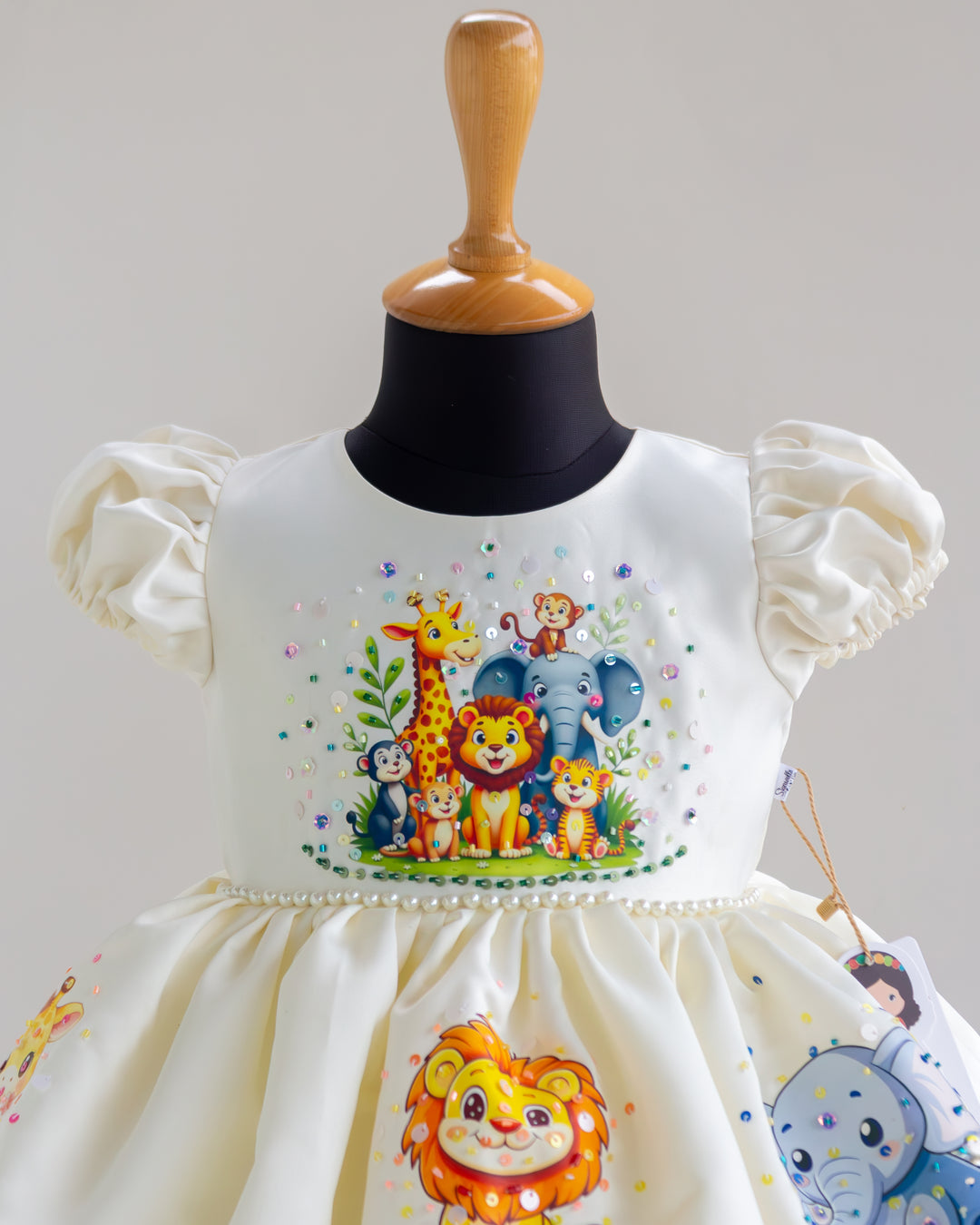 Jungle theme handwork detailing on off white silky satin partywear frock – Stanwells Kids