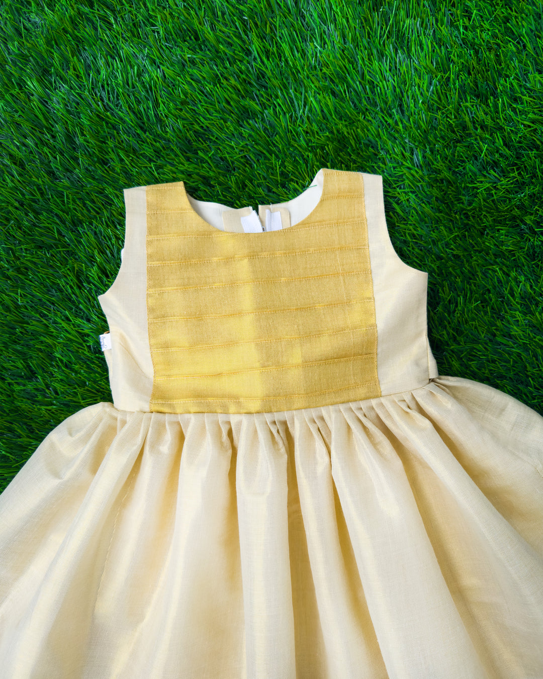 Cream base with golden Kasavu accents on Onam tissue frock – Stanwells Kids