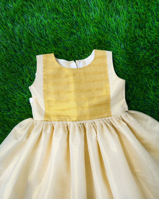 Cream base with golden Kasavu accents on Onam tissue frock – Stanwells Kids