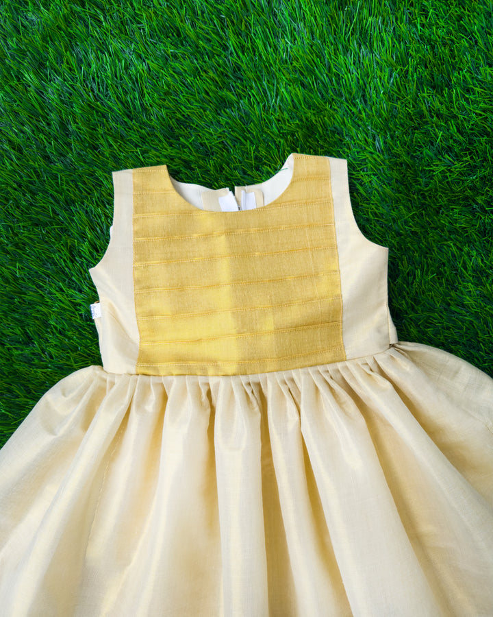 Cream base with golden Kasavu accents on Onam tissue frock – Stanwells Kids