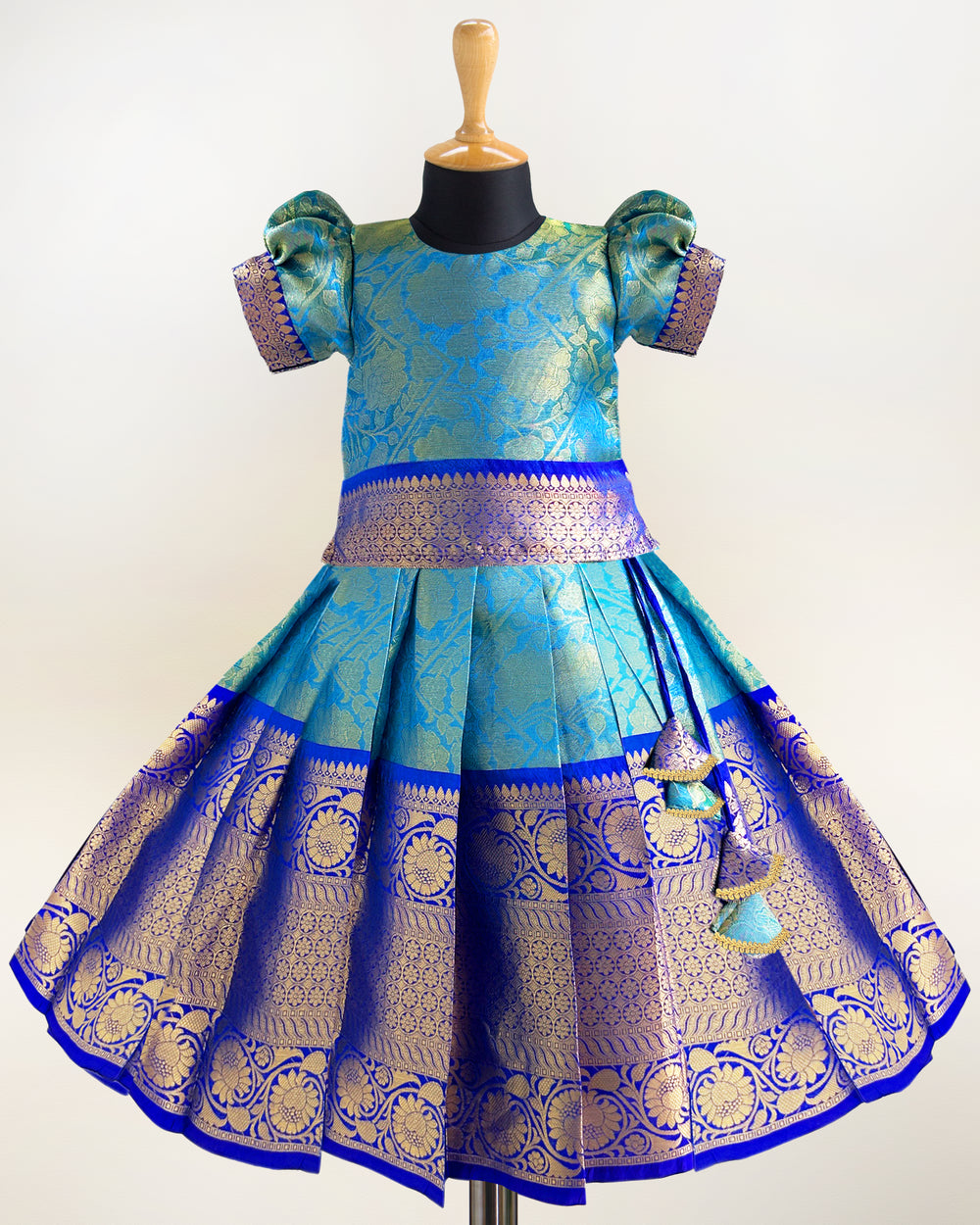 Peacock blue Banarasi silk lehenga choli for baby girls

Traditional puff sleeve dress for kids

Banarasi silk birthday dress for girls

Baby girls ethnic wear lehenga

Festive partywear dress for toddlers

Peacock blue traditional frock for baby girls

Stanwells Kids Banarasi birthday collection