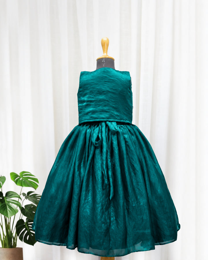 Back view of peacock green ethnic handwork jacket gown for baby girl highlighting its elegant design and neat finishing.