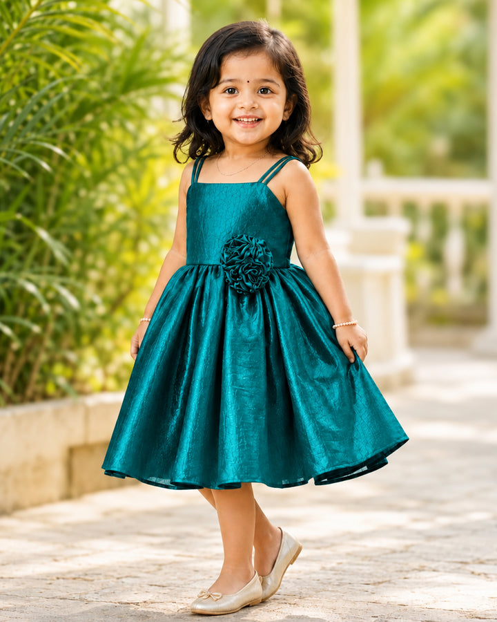 Baby girl wearing a peacock green velvet organza strap sleeve frock, perfect for birthdays and special occasions.
