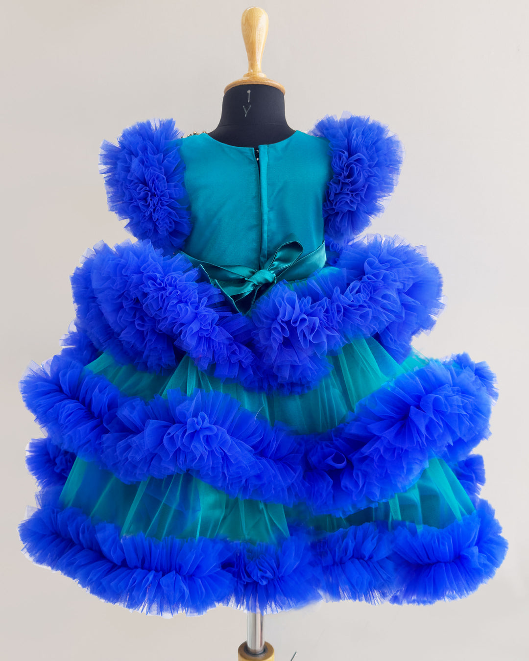 Peacock and royal blue birthday dress for girls with heavy handwork and 3-step ruffles, ideal for parties and special occasions.