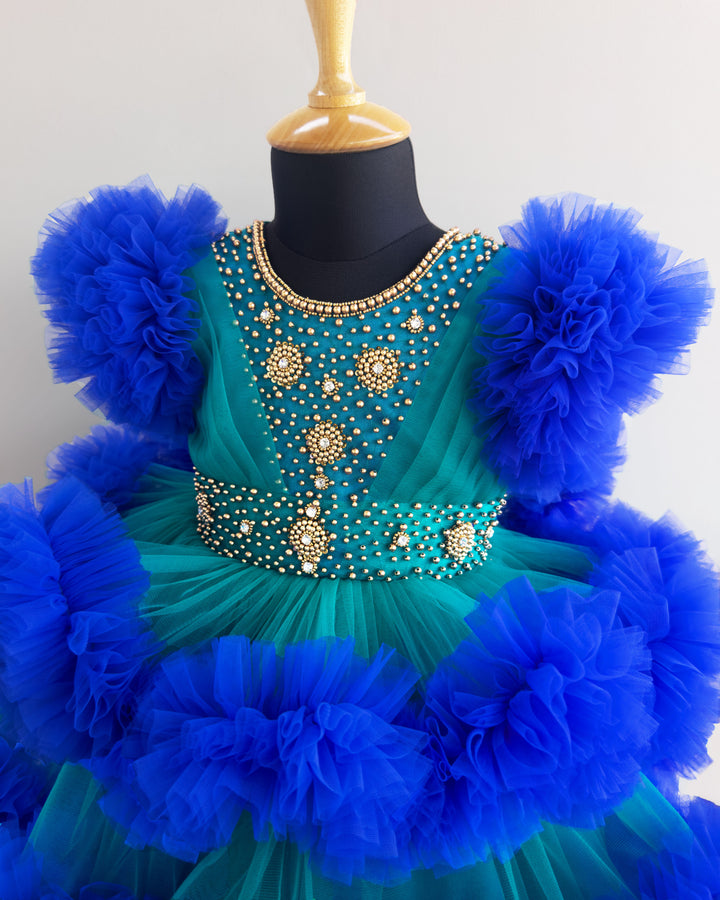 Peacock and royal blue birthday dress for girls with heavy handwork and 3-step ruffles, ideal for parties and special occasions.