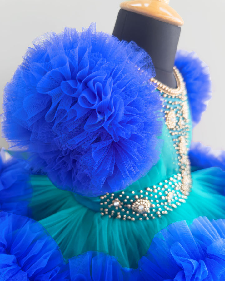 Peacock and royal blue birthday dress for girls with heavy handwork and 3-step ruffles, ideal for parties and special occasions.