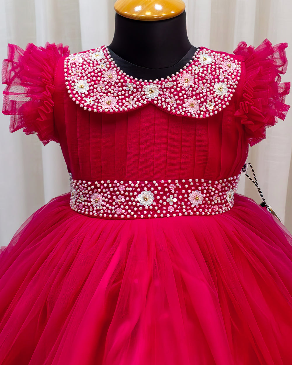 Rani pink birthday dress for baby girl with handwork

Baby girl partywear frock in rani pink shade

Peter collar pleated birthday dress for toddler girl

Rani pink baby girl frock satin lining back view

Handwork rani pink birthday dress close up detail

Baby girl first birthday partywear pink frock

Designer rani pink frock for baby girl celebration

Toddler girl birthday dress with pleated yoke