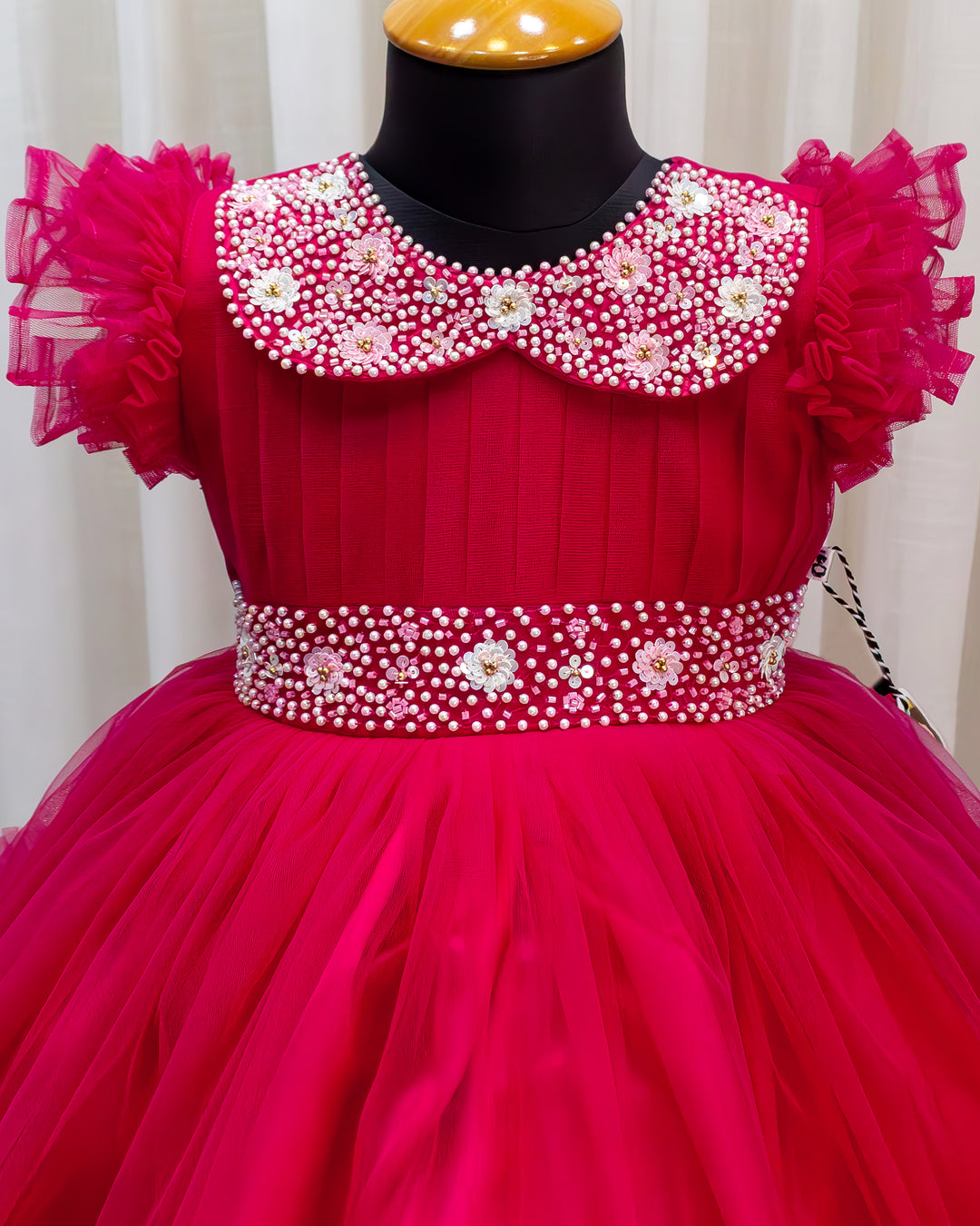 Rani pink birthday dress for baby girl with handwork

Baby girl partywear frock in rani pink shade

Peter collar pleated birthday dress for toddler girl

Rani pink baby girl frock satin lining back view

Handwork rani pink birthday dress close up detail

Baby girl first birthday partywear pink frock

Designer rani pink frock for baby girl celebration

Toddler girl birthday dress with pleated yoke