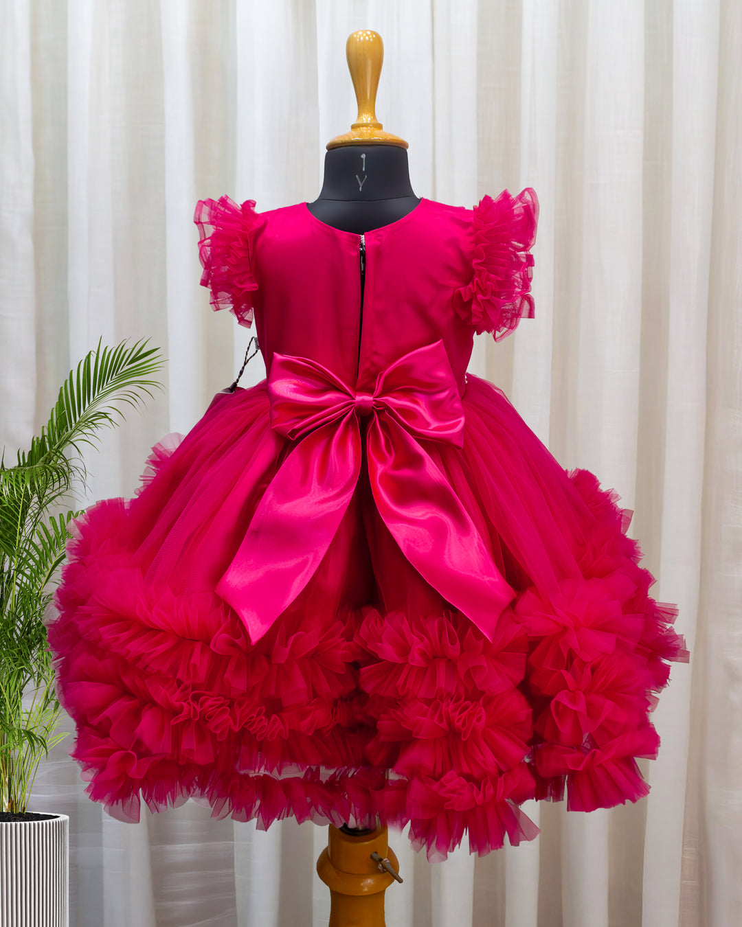 Rani pink birthday dress for baby girl with handwork

Baby girl partywear frock in rani pink shade

Peter collar pleated birthday dress for toddler girl

Rani pink baby girl frock satin lining back view

Handwork rani pink birthday dress close up detail

Baby girl first birthday partywear pink frock

Designer rani pink frock for baby girl celebration

Toddler girl birthday dress with pleated yoke