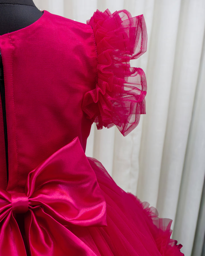 Rani pink birthday dress for baby girl with handwork

Baby girl partywear frock in rani pink shade

Peter collar pleated birthday dress for toddler girl

Rani pink baby girl frock satin lining back view

Handwork rani pink birthday dress close up detail

Baby girl first birthday partywear pink frock

Designer rani pink frock for baby girl celebration

Toddler girl birthday dress with pleated yoke
