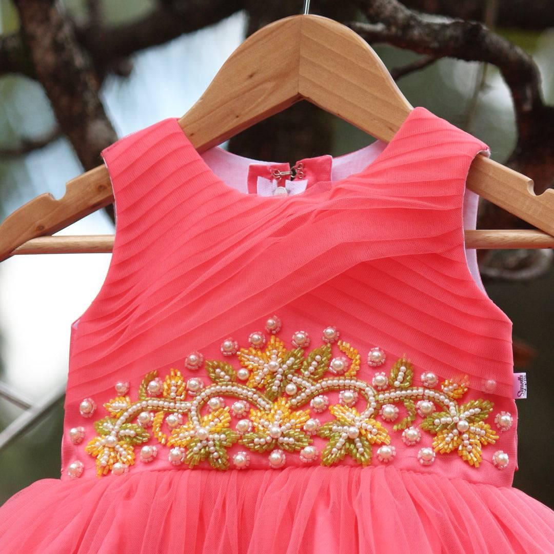 Peach Beads Handwork Birthday Frock
Material: Peach mono net with layered and ruffles on the end portion. Yoke portion is designed with pleated pattern and mukti colour beads handwork in the centre po