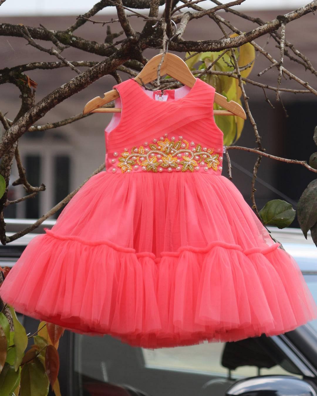 Peach Beads Handwork Birthday Frock
Material: Peach mono net with layered and ruffles on the end portion. Yoke portion is designed with pleated pattern and mukti colour beads handwork in the centre po