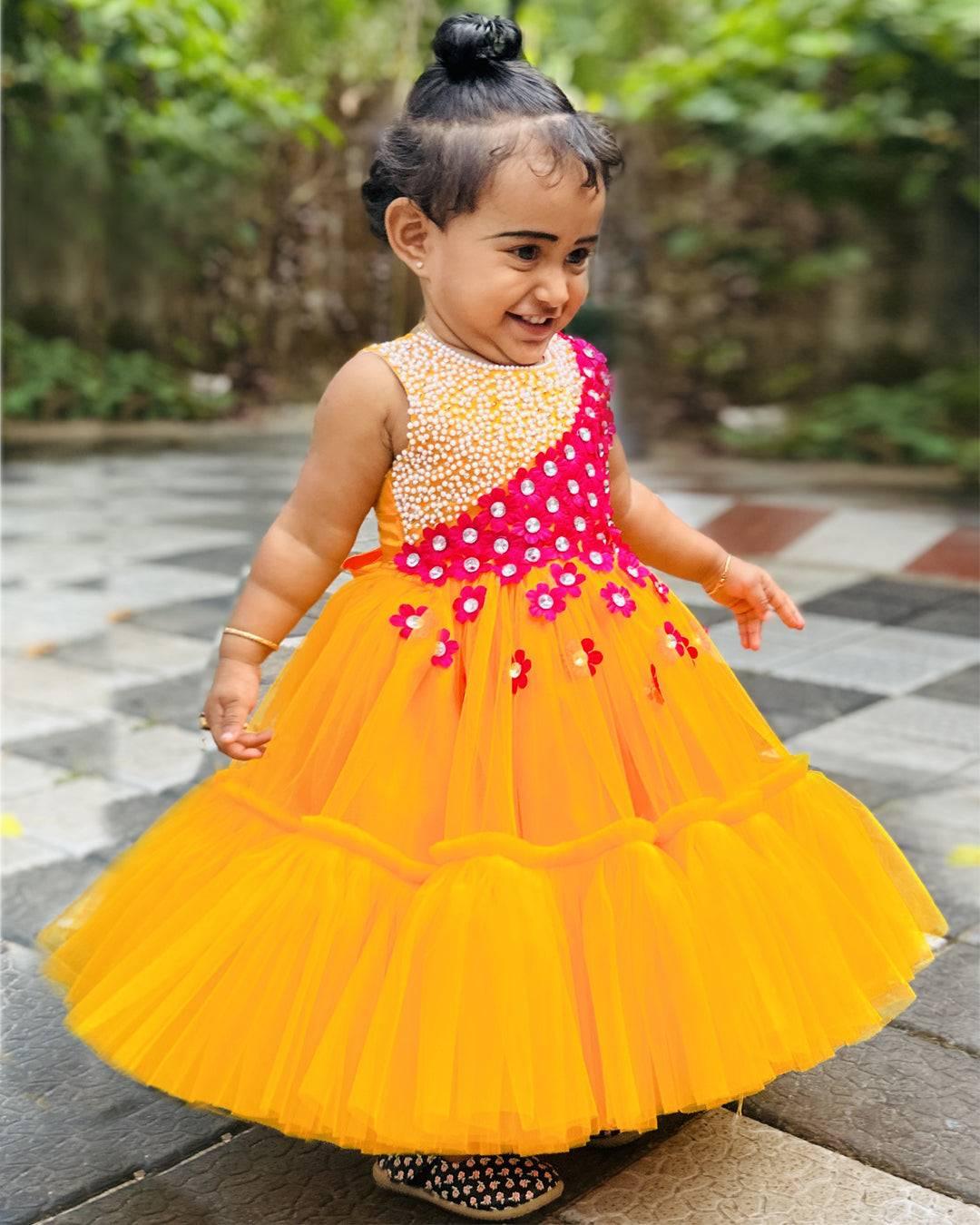 Mango Yellow & Magenta combo Handwork Flower Frock
Material: Mango yellow colour net is used to make this elegant dress. Magenta colour satin flowers are spreaded on one side of the frock. Another side of the frock 