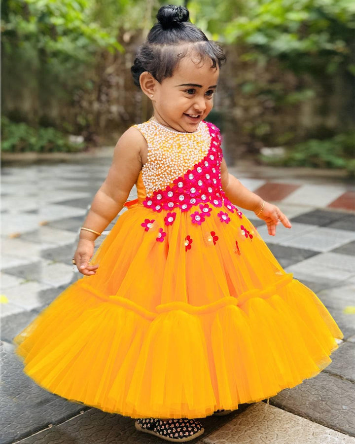 Mango Yellow & Magenta combo Handwork Flower Frock
Material: Mango yellow colour net is used to make this elegant dress. Magenta colour satin flowers are spreaded on one side of the frock. Another side of the frock 