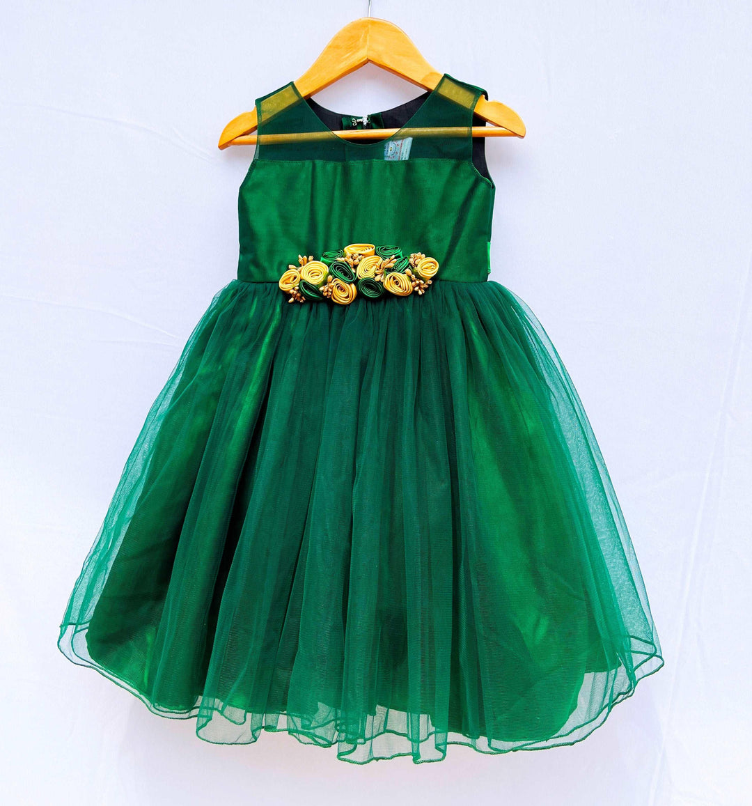 Bottle Green Knee-Length Flower Frock
Fabric:  Bottlle Green shade  mono net with green and golden mix flowers on the centre portion.  Neck is designed in Transparent pattern. Beautifully designed outfi