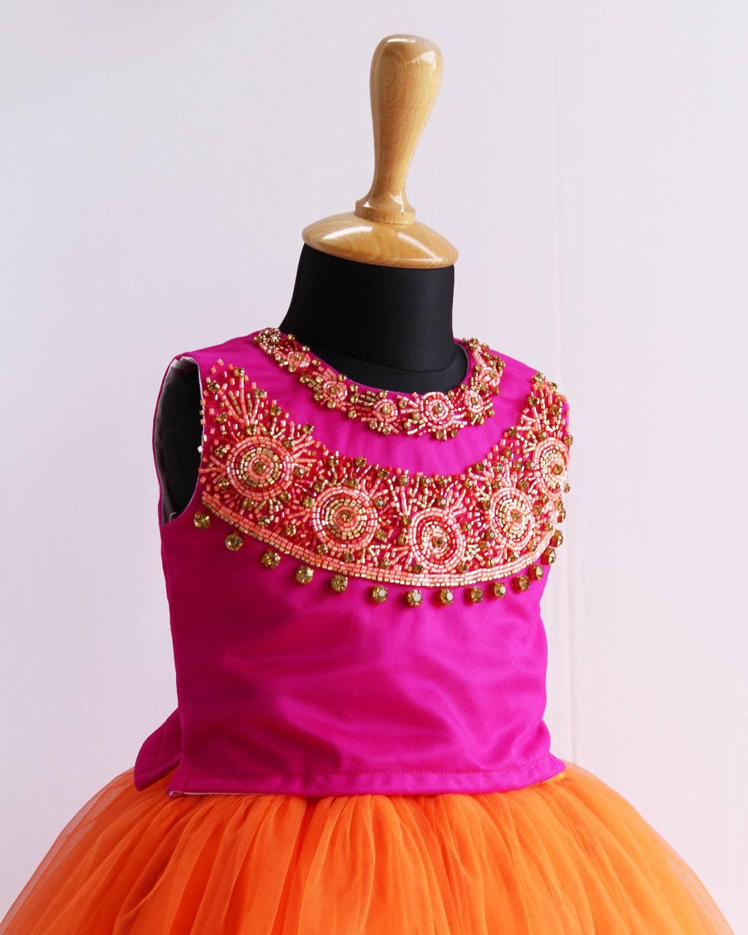 Orange & Magenta combo Heavy Handwork Skirt & Top
Material: Orange &amp; Magenta combo soft nylon net is used for making this beautiful skirt &amp; top .Top portion of the dress is designed with magenta colour net 