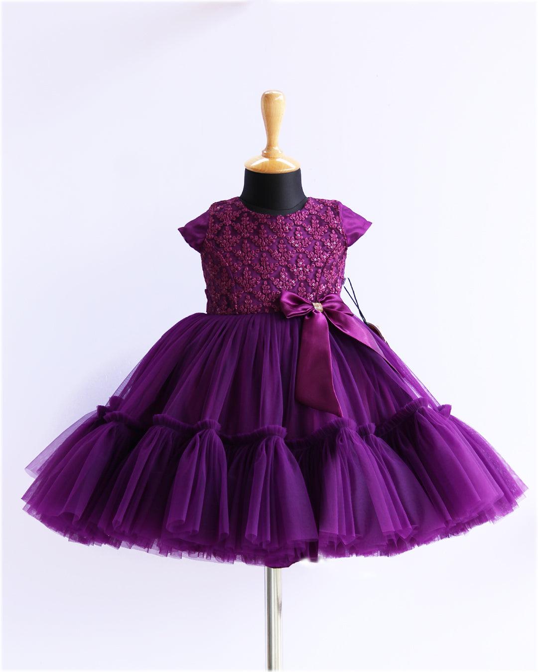 Purple Sequins Thread Embroidery Flared Ruffles Birthday Frock
Material: Purple mono nylon soft net fabric is used for the bottom of the skirt. End of the frock is designed in a pleated ruffles pattern. Yoke portion is designed