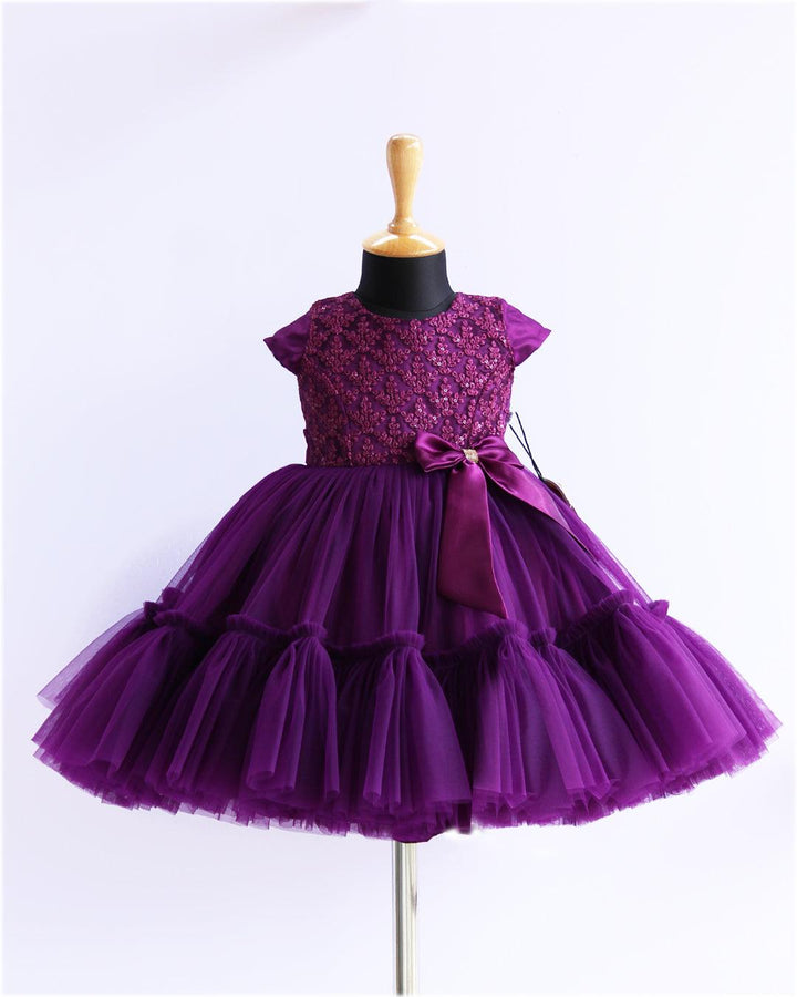 Purple Sequins Thread Embroidery Flared Ruffles Birthday Frock
Material: Purple mono nylon soft net fabric is used for the bottom of the skirt. End of the frock is designed in a pleated ruffles pattern. Yoke portion is designed
