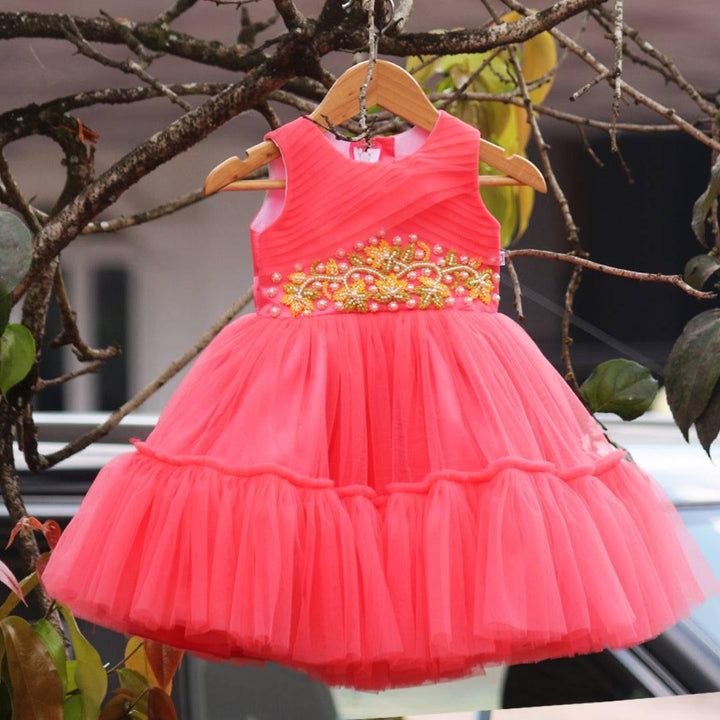 Peach Beads Handwork Birthday Frock
Material: Peach mono net with layered and ruffles on the end portion. Yoke portion is designed with pleated pattern and mukti colour beads handwork in the centre po
