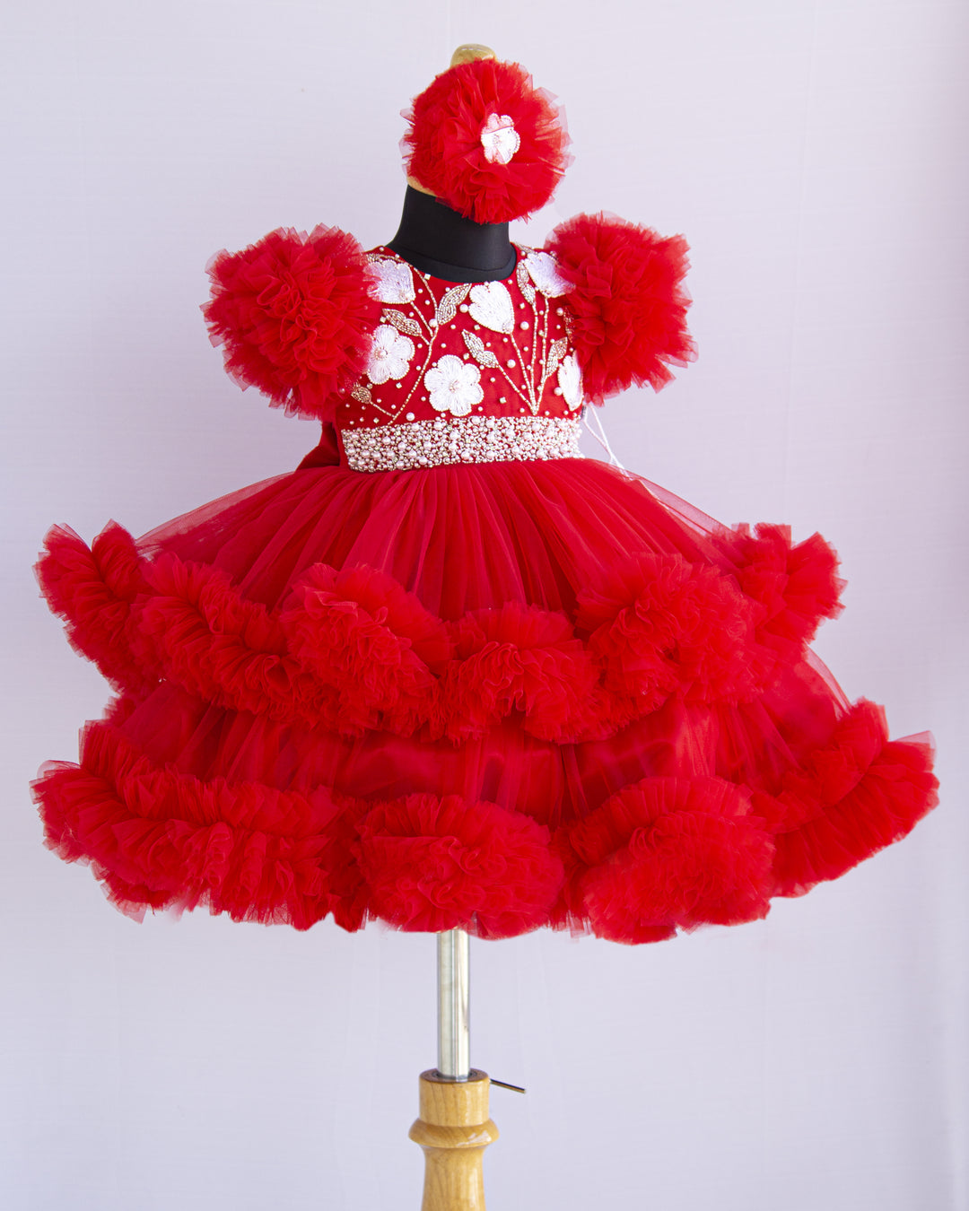 Red Shade Handwork Heavy Ruffles Baby-Girls Partywear Frock
Material: Red shade handwork baby-girls step frock is made with soft mono nylon net fabric. Yoke part is designed with white flower and beads handwork. White pearls