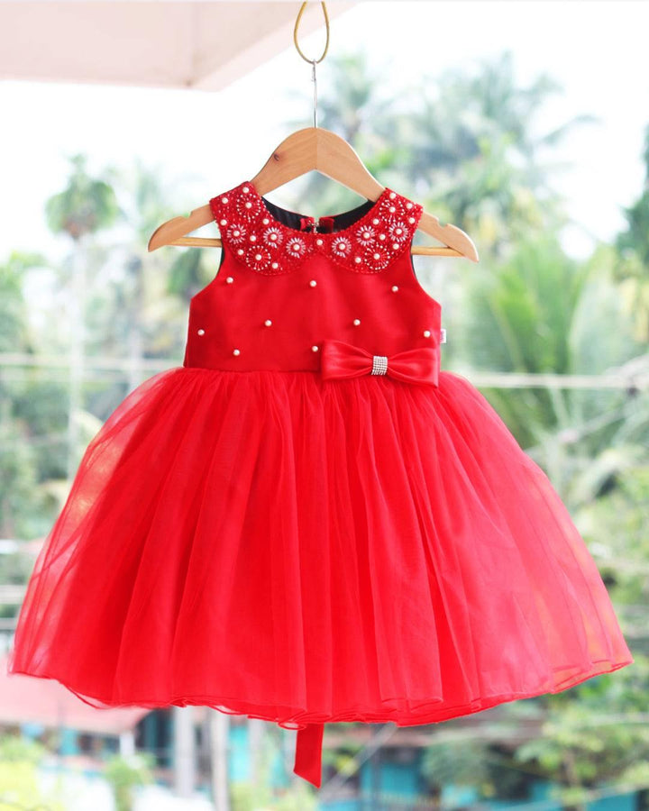 Red Colour Hand Embroidery Knee-Length Frock.
Material: Red colour soft quality nylon net fabric with premium matching ultra satin material is used for glossy feel.Yoke portion of the frock is designed with Whi