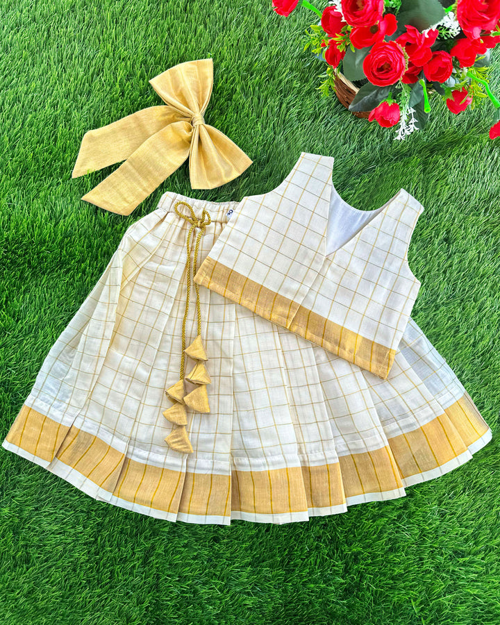 onam 2024 | onam dresses for kids | stanwells kids | golden dresses | kasavu kerala dresses kids | noolukeettu dress for kids | nakshatra kids | a r handlooms | handloom dresses for kids | matching hanging bow | check lehenga kids | kids pattupavadai | girls lehenga choli 