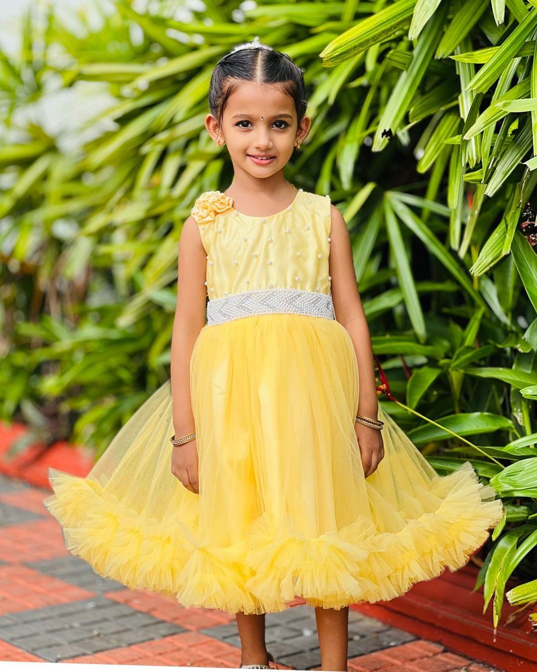 Yellow Ruffled Beaded Frock with Flowers
Material: Yellow nylon mono net with inner portion is covered with premium ultra satin and white cotton lining.
Colour: Yellow | Sleeve Type: Sleeveless | Item Leng