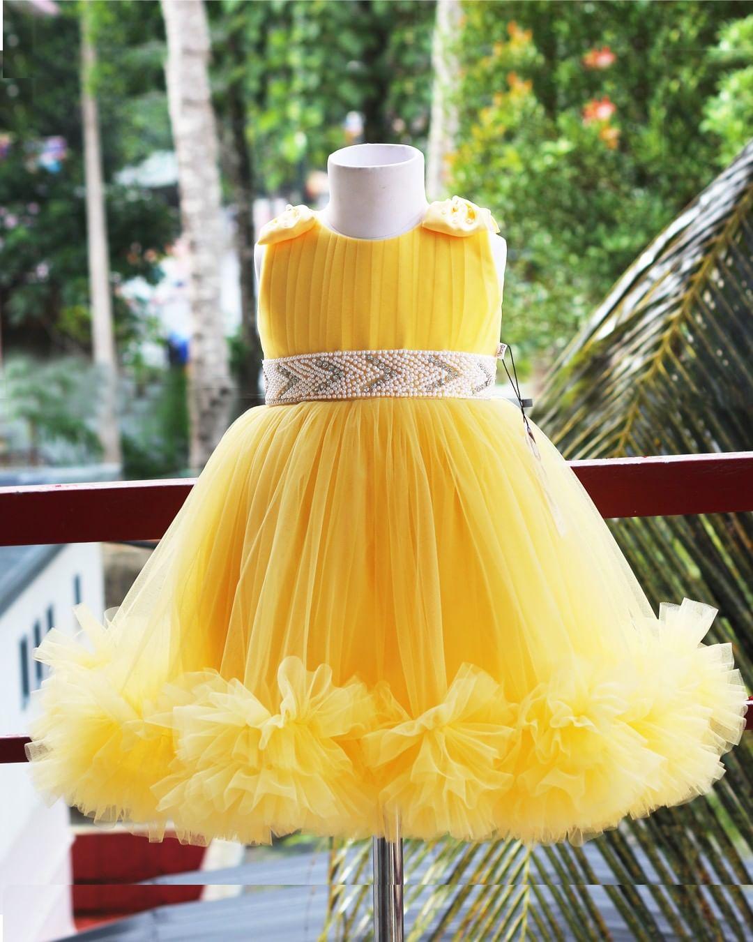 Yellow Ruffled Pleated Bow Frock
Material:  Yellow nylon mono net with inner portion is covered with premium ultra satin and white cotton lining.
Colour: Yellow | Sleeve Type: Sleeveless | Item Len