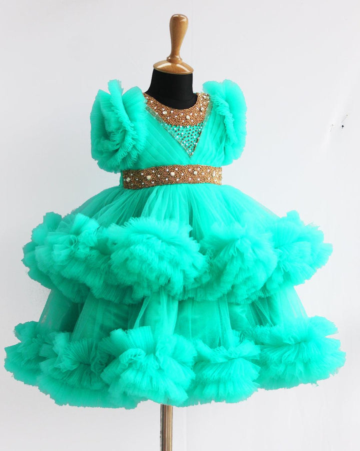 Sea Green Handwork Two Layer Ruffled Frock
Material: Sea Green Shade Pleated Ruffled Frock mono net with layered and ruffles on the end portion. Yoke portion is designed with pleated pattern and golden beade