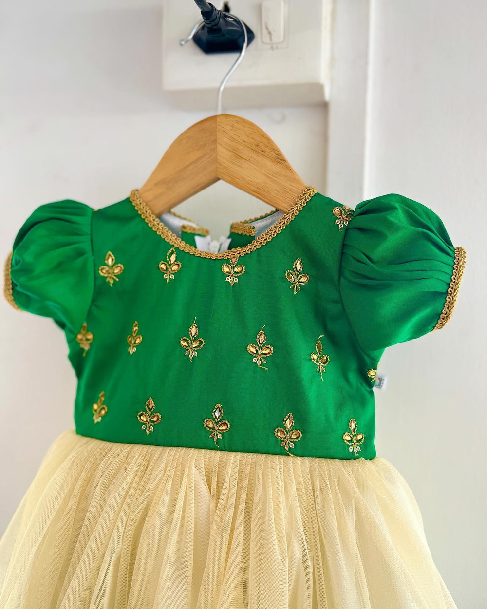 Cream & Green Traditional Embroidery Stone work Frock
Material: Green Taffetta silk top with golden embroidery stone work, Cream soft net skirt with matching border. Beautifully designed outfit for baby girls with smoo