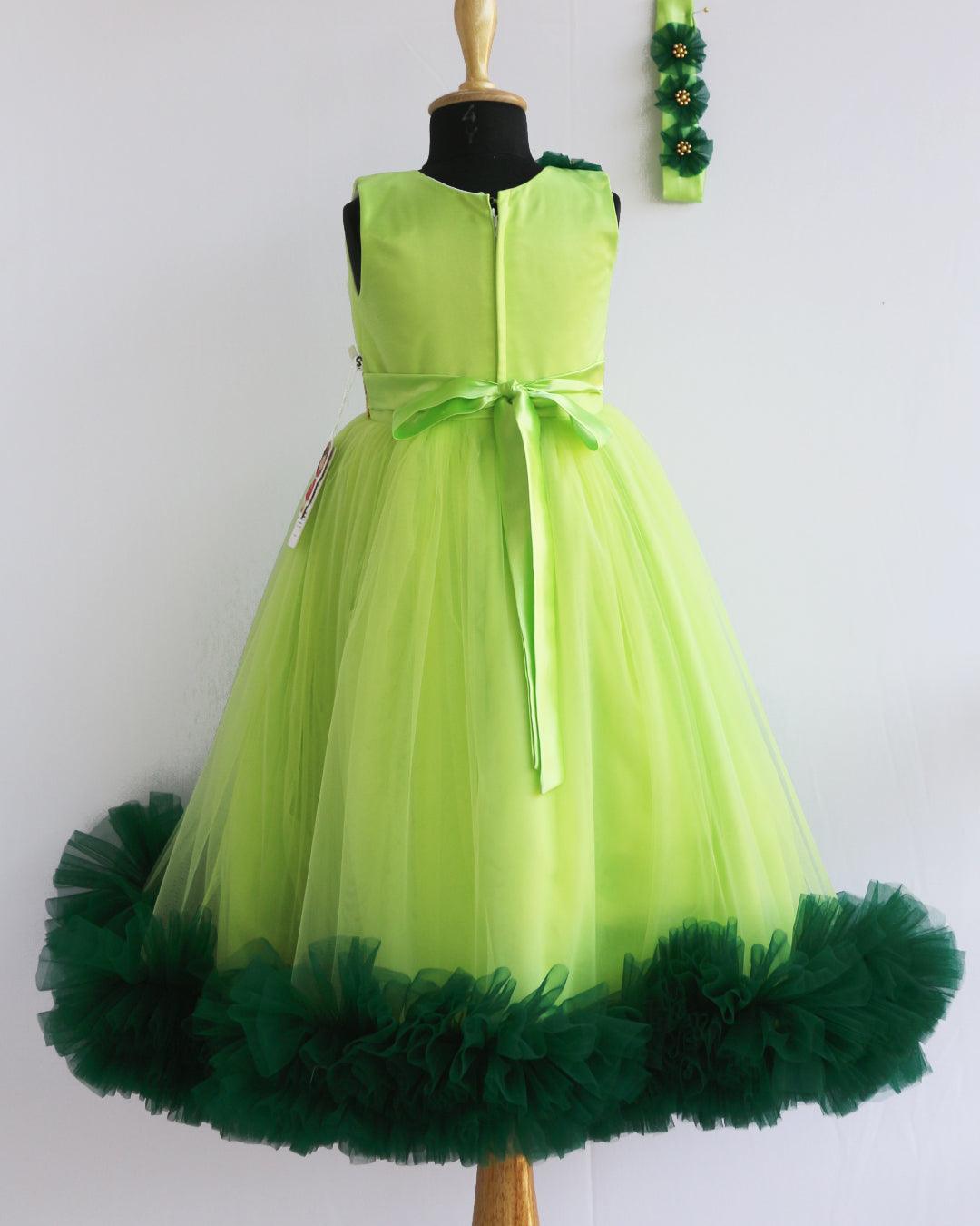 Light Green Pleated Ruffles Gown- Matching Hairband
Material : Light green mono nylon net fabric with bottle green net ruffles on the end portion. Yoke portion is designed in a pleated pattern. Center portion has a g
