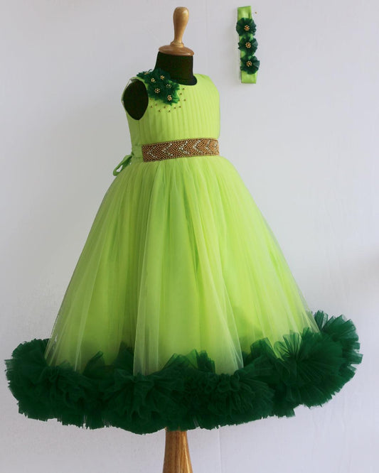 Light Green Pleated Ruffles Gown- Matching Hairband
Material : Light green mono nylon net fabric with bottle green net ruffles on the end portion. Yoke portion is designed in a pleated pattern. Center portion has a g