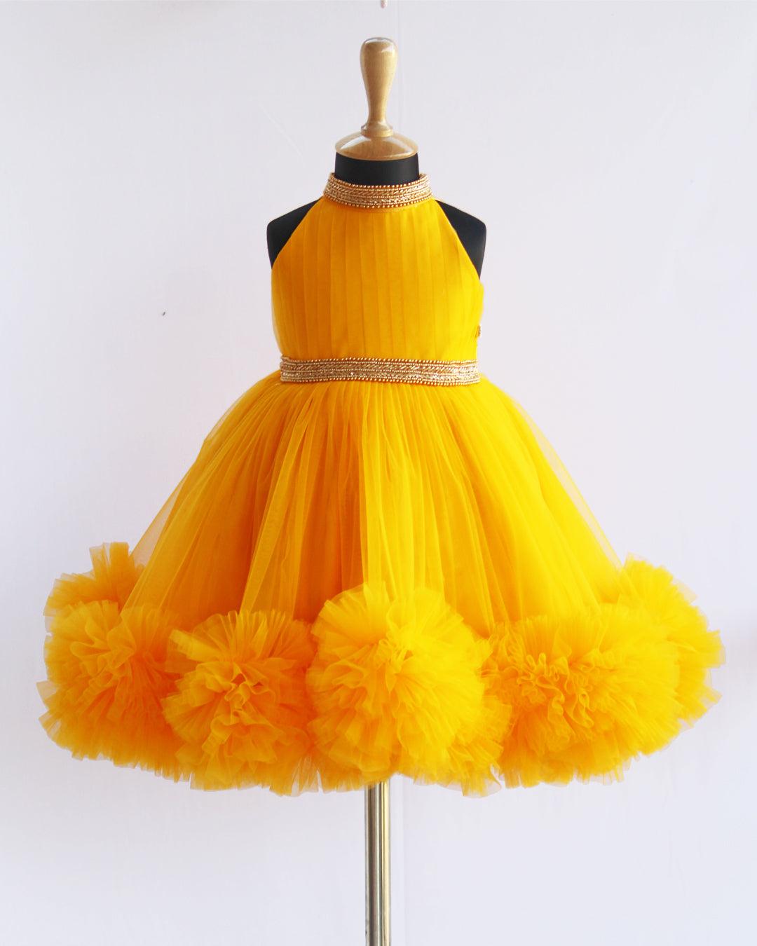 Mango Yellow Pleated Halter Neck Ruffled Frock.
Material : Mango Yellow  soft mono nylon net is mainly used for making this dress. Yoke portion is designed in a pleated pattern with halter neck design. Skirt port